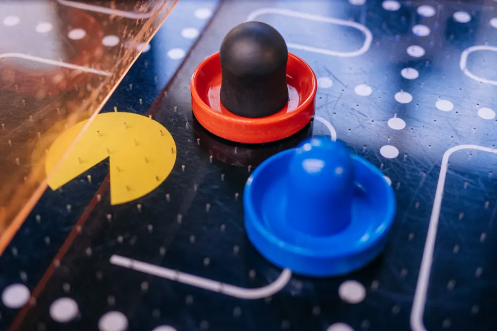 Air hockey mallets and puck on a retro table