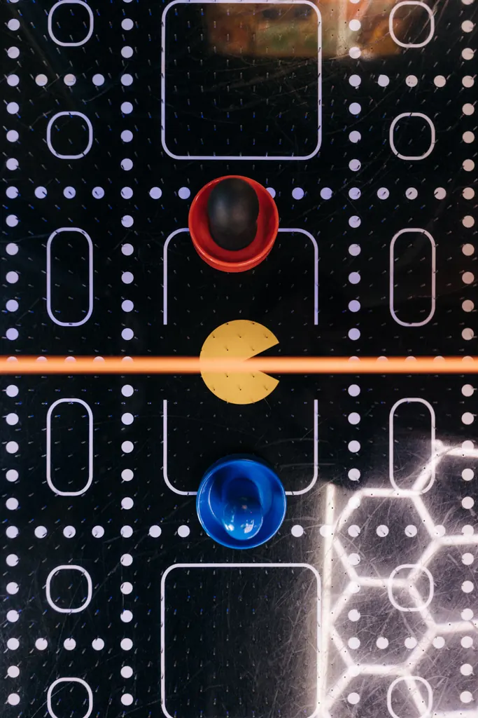 Retro arcade-style air hockey table seen from above