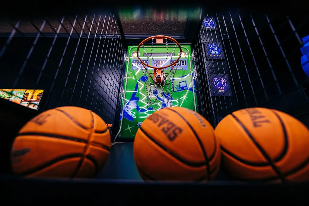 Arcade basketball game with basketballs lined up