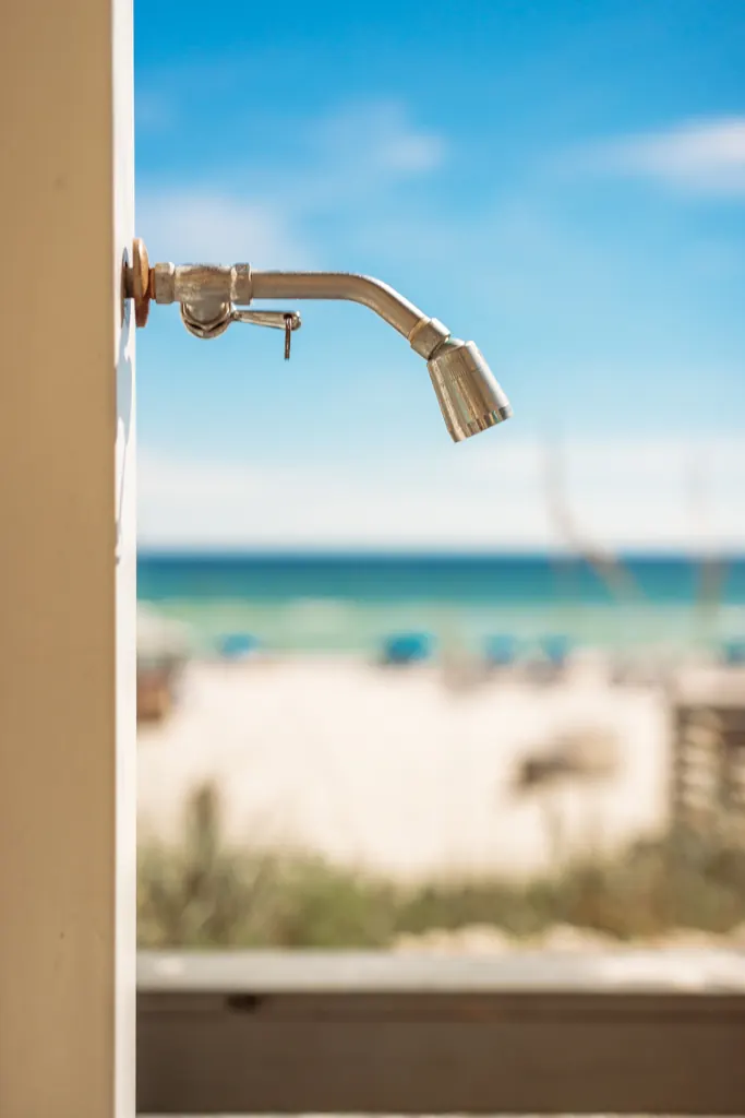 Outdoor rinse shower with the beach and Gulf in the background