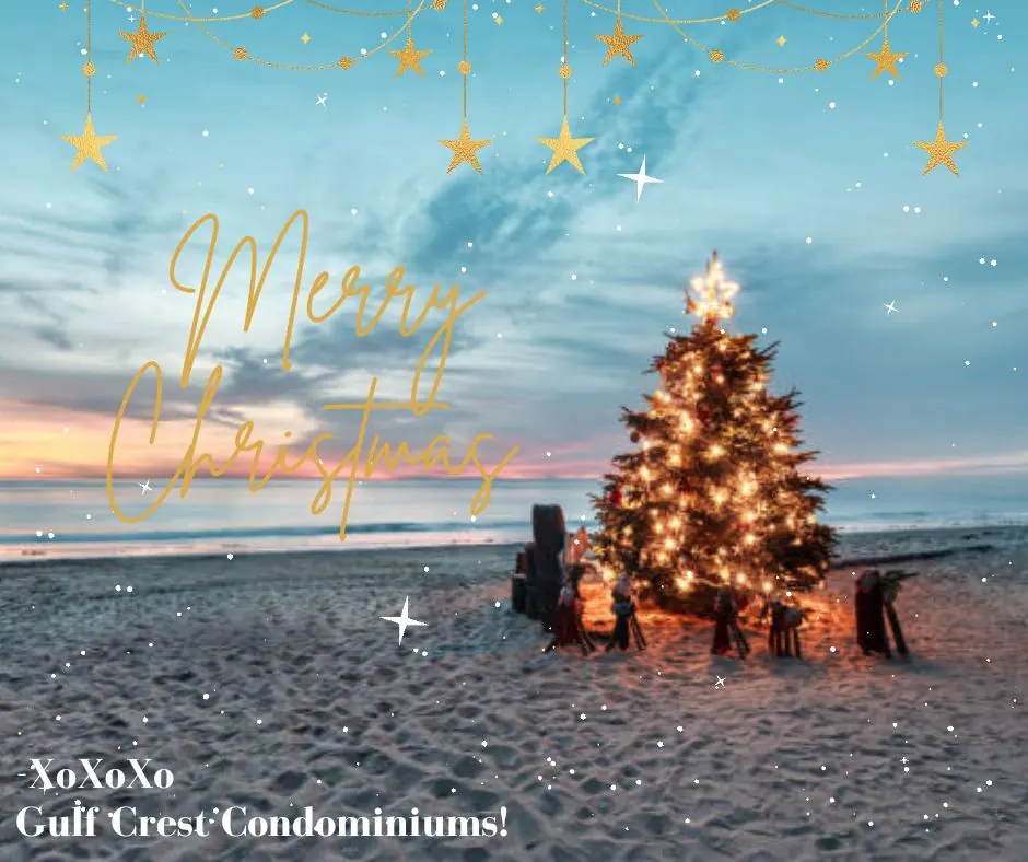 Christmas tree on the beach at sunset with a Merry Christmas message from Gulf Crest Condominiums