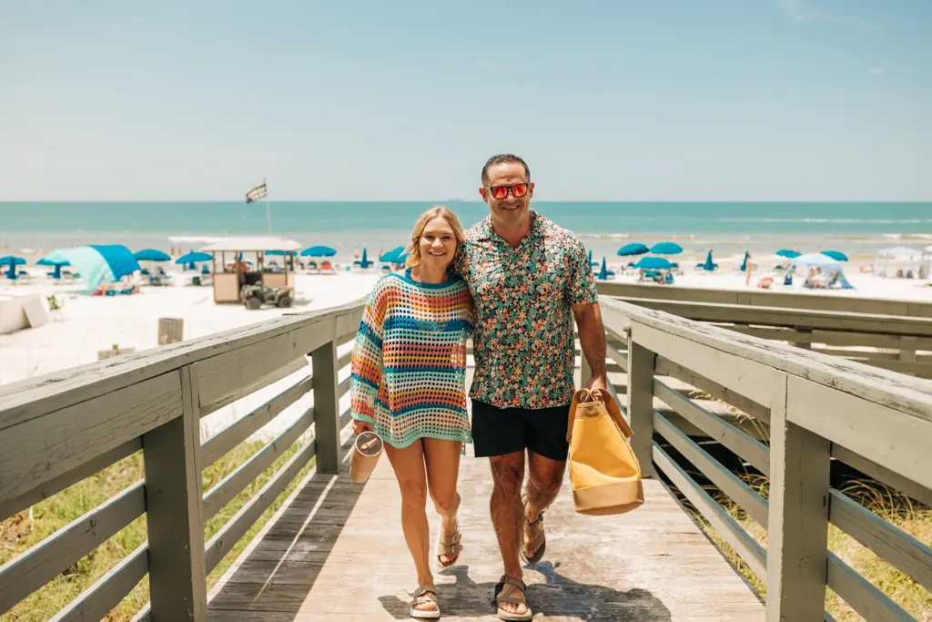Couple walking the boardwalk from the beach at Gulf Crest