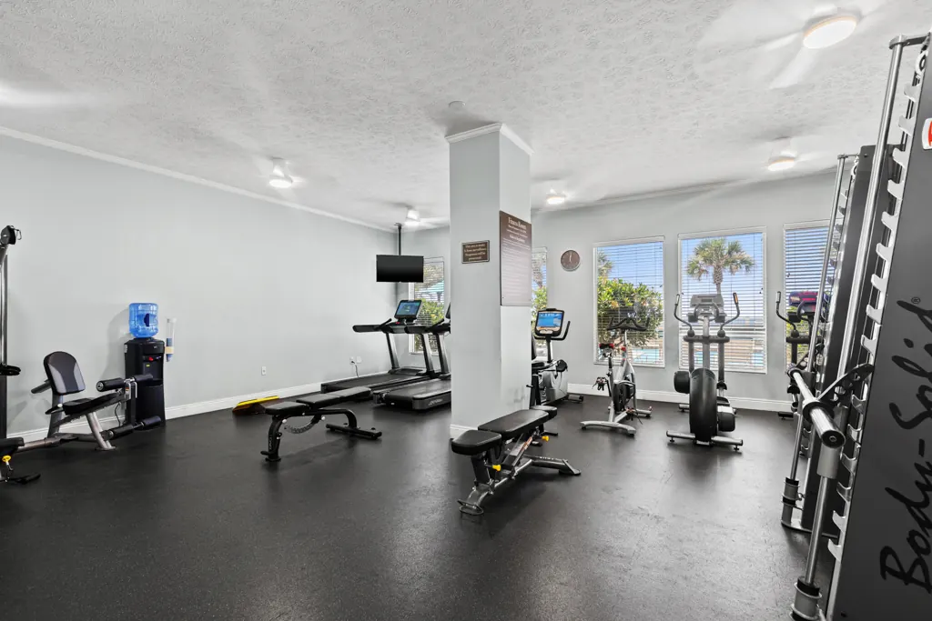 Gulf Crest fitness center with treadmills, weights and bright windows
