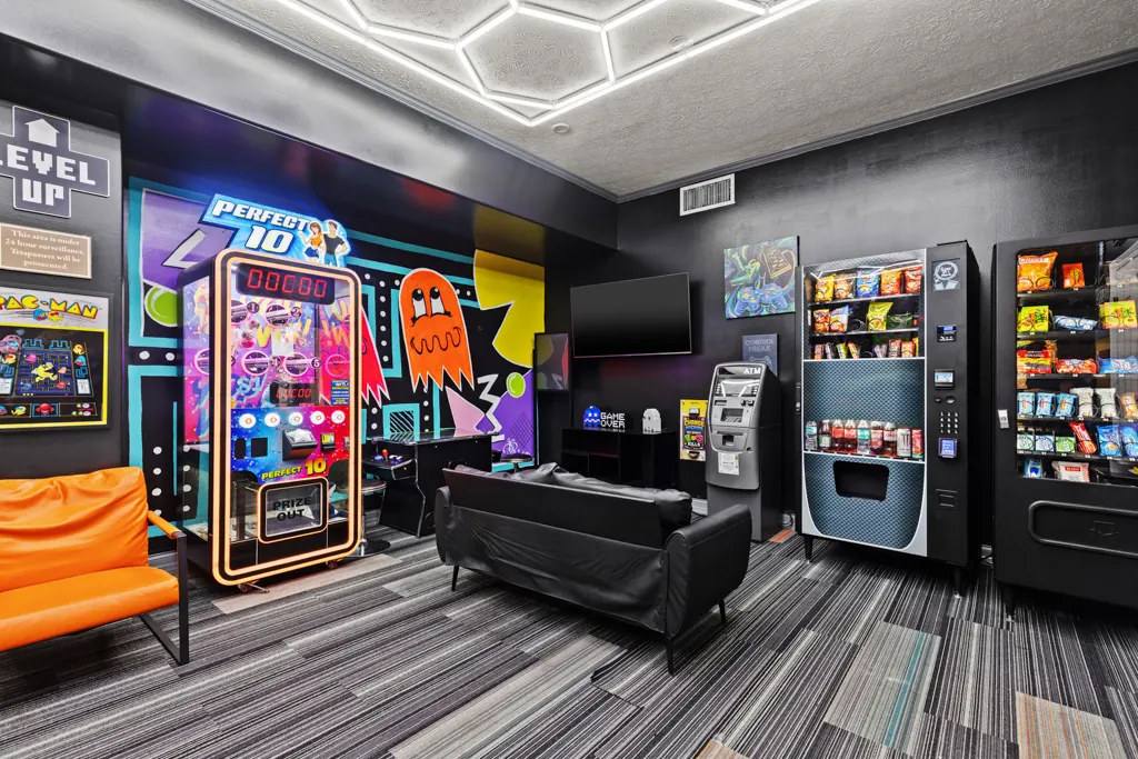 Game room lounge with sofas, claw machine and vending machines