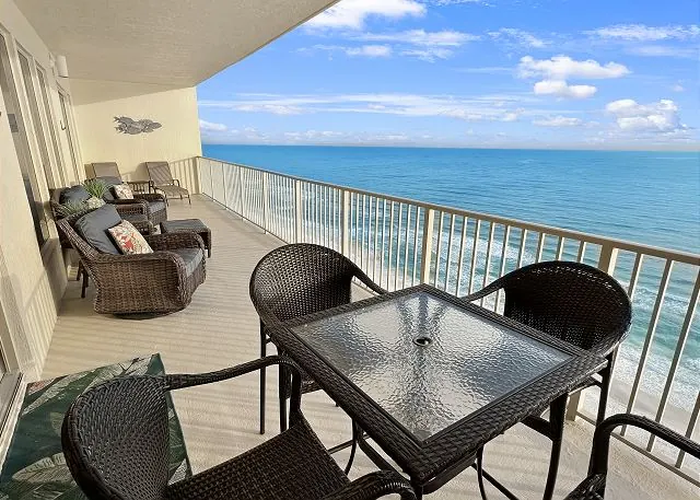 Balcony table and chairs overlooking the beach and the Gulf