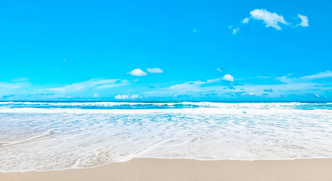 Turquoise surf and white sand on the beach at Gulf Crest Condominiums