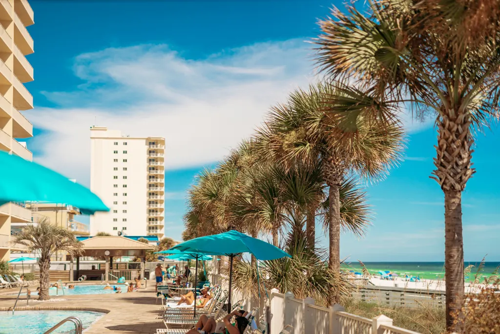 Gulf Crest tower with palm trees and the pool deck