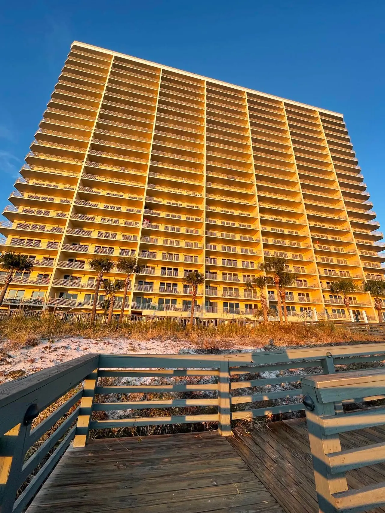 Gulf Crest tower glowing in the evening sun above the boardwalk