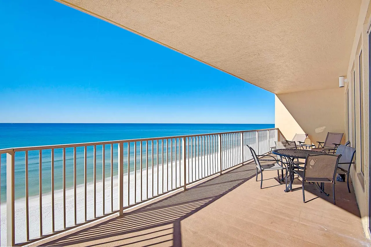 Oversized private balcony with chairs overlooking the beach and the Gulf