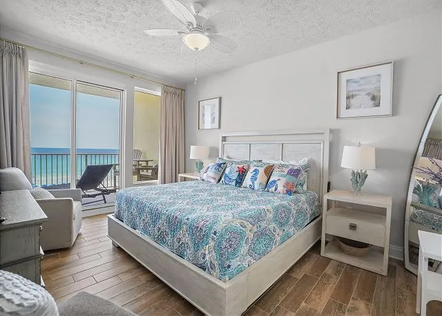 Bedroom with a king bed and a balcony door looking out over the Gulf of Mexico