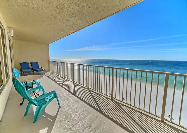 Long oversized balcony with lounge chairs along the Gulf-front side of a Gulf Crest condo