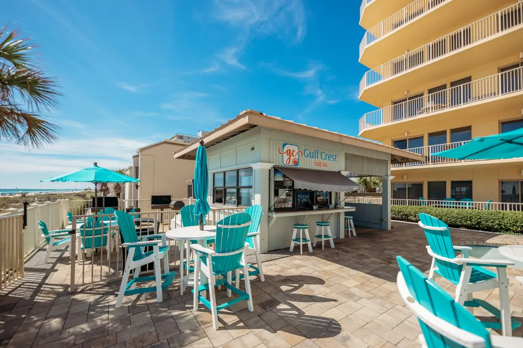 Pool deck seating near the Gulf Crest Social bar and the tower