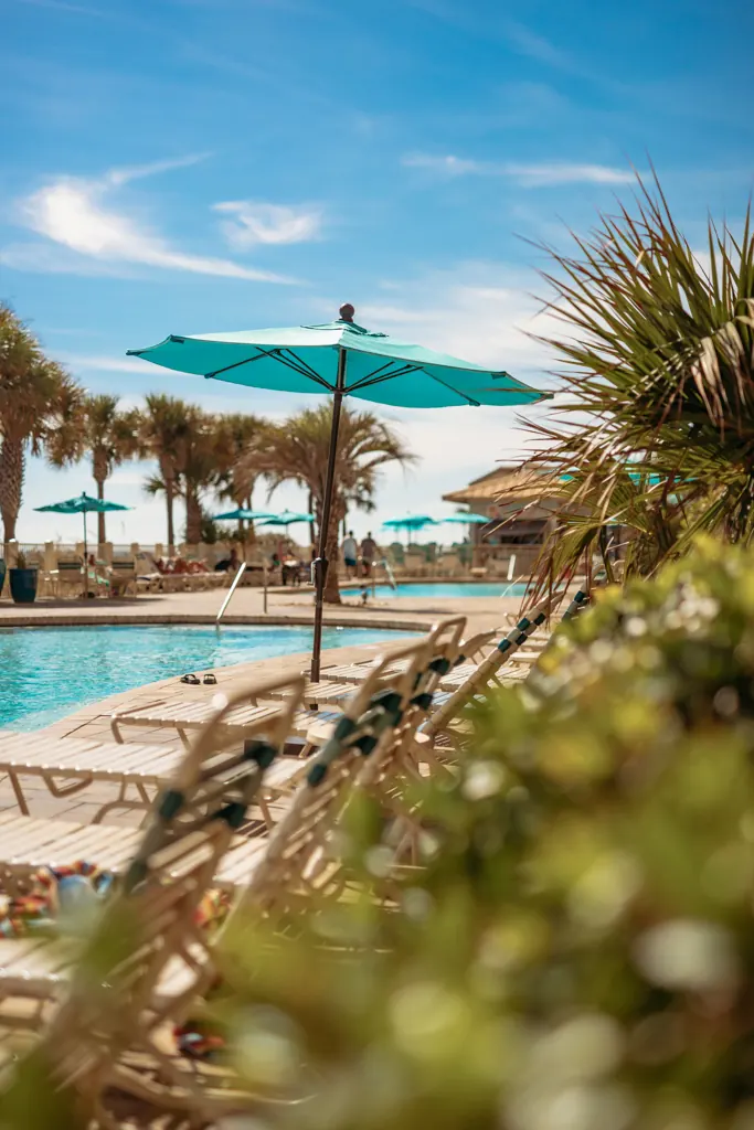 Poolside umbrellas and palms on the Gulf Crest pool deck
