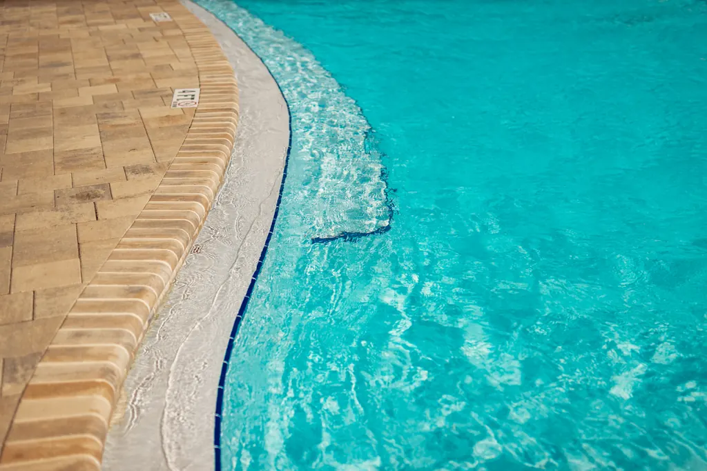 Turquoise pool water along the curved pool edge